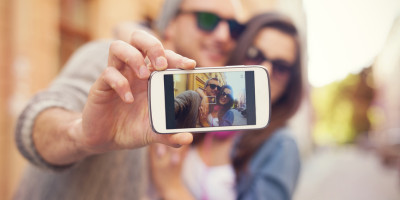 Young couple taking selfie in the city
